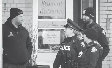  ?? TIJANA MARTIN / THE CANADIAN PRESS ?? Toronto police respond to a bomb threat at St. Michael’s College School in Toronto on Monday, on the same day that six teens from the all-boys private school were charged in connection with an alleged gang sexual assault.