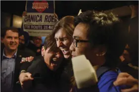  ??  ?? Danica Roem (center), a Democrat who ran for Virginia’s House of Delegates against GOP incumbent Robert Marshall, is greeted by supporters as she prepares to give her victory speech Tuesday in Manassas, Va. Roem, a former journalist, is set to make...