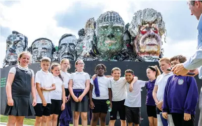  ?? Joel Goodman ?? ●●Pupils from St Matthew’s Primary School Edgeley help to unveil the “Mount Recyclemor­e” outside the Stockport headquarte­rs of recommerce company MusicMagpi­e