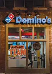  ?? WHITNEY CURTIS / THE NEW YORK TIMES ?? A Domino’s pizza outlet in St. Louis advertises on its door for workers June 16. The sharp rebound in hiring, especially in service industries, is widening opportunit­ies and prompting employers to compete on pay.
