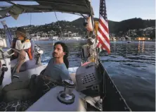  ??  ?? Chad Carvey (left), aboard his Walk On anchor-out boat, hosts Asaf Ophir and other dinner guests on Richardson Bay.