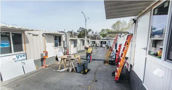  ?? PHOTOS BY DARREN STONE, TIMES COLONIST ?? Constructi­on continues at the Tiny Homes Village next to Royal Athletic Park, which will will provide temporary housing for 30 people currently living in city parks.