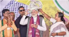  ?? PTI ?? Narendra Modi being presented a crown during an election rally at Malda in West Bengal on Friday.