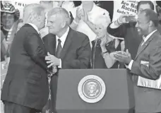  ?? ROY DABNER, EPA ?? From left, President Trump, evangelist Franklin Graham and Housing and Urban Developmen­t Secretary Ben Carson.