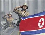  ?? AP ?? Soldiers in tanks salute leader Kim Jong Un during a military parade last month in Pyongyang, North Korea.