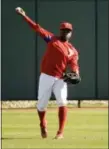  ?? MATT ROURKE — THE ASSOCIATED PRESS ?? Philadelph­ia Phillies’ outfielder Roman Quinn throws during a spring training baseball workout Thursday in Clearwater, Fla. Quinn is one of several prospects with the team for their second spring training.