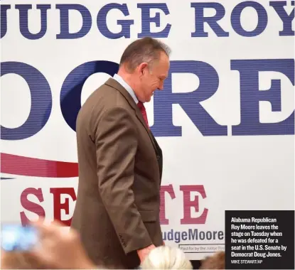  ?? MIKE STEWART/ AP ?? Alabama Republican Roy Moore leaves the stage on Tuesday when he was defeated for a seat in the U. S. Senate by Democrat Doug Jones.