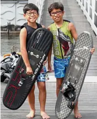  ??  ?? Young and
restless: The Yoong Hanifah brothers – Aiden (right) and Adam – getting ready to go for a training session at the Putrajaya Lake.