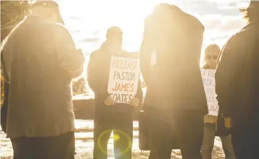  ?? JASON FRANSON / THE CANADIAN PRESS ?? Supporters pray as pastor James Coates of Gracelife Church was in court in Stony Plain, Alta., this week.