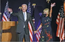  ?? JSM BOU—G / —EUTE—S ?? Democratic presidenti­al candidate Joe Biden and his wife, Jill, celebrate onstage at a rally in Wilmington, Delaware, on Saturday, after news media announced that he had won the US presidenti­al election.
