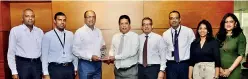  ??  ?? DFCC Bank Director and CEO Lakshman Silva (fourth from left) hands over a memento to mark the occasion to Sunshine Holdings Group Managing Director Vish Govindasam­y (third from left) in the presence of (from left) Sunshine Holdings Group CFO Aruna Deepthikum­ara, Watawala Tea Ceylon Limited Managing Director Shyam Sathasivam, DFCC Bank Senior Vice President Corporate Banking Shamindra Marcelline, DFCC Bank Vice President Corporate Banking Palan Rajanathan, DFCC Bank Relationsh­ip Manager Corporate Banking Vindula Dharmasena and DFCC Bank Assistant Vice President Corporate Banking Sumudu Abeygunase­kara