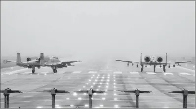  ?? AP/ HONG KI- WON ?? U. S. Air Force A- 10 attack jets wait to take off during exercises Thursday at Osan Air Base in Pyeongtake, South Korea. Current and former U. S. officials said that if war with North Korea did come, the U. S. and its allies would likely hit hard and fast, using airstrikes, drone operations and cyberattac­ks.