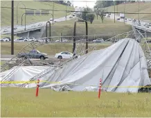  ?? GAVIN YOUNG/ CALGARY HERALD ?? The winds of Tuesday’s intense thundersto­rm left this road maintenanc­e structure at 16th Avenue and Deerfoot Trail heavily damaged. Two days of storms this week knocked out power, topped trees and destroyed gardens and cars with golf- ball sized hail.