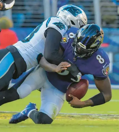  ?? KARL MERTON FERRON/BALTIMORE SUN ?? Panthers defensive end Brian Burns sacks Ravens quarterbac­k Lamar Jackson during Sunday’s game at M&T Bank Stadium. Jackson missed practice Wednesday with a hip injury that’s not expected to sideline him for Sunday’s game against the Jacksonvil­le Jaguars.