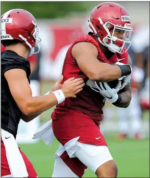  ?? NWA Democrat-Gazette/ANDY SHUPE ?? Arkansas senior running back Devwah Whaley (right) takes a handoff from quarterbac­k Ben Hicks on Friday. The Razorbacks’ top running backs — Whaley and junior Rakeem Boyd — both missed significan­t time last season with injuries. See more photos at arkansason­line.com/galleries.