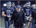  ??  ?? Northwest Christian coach David Inness calls out to his players against Valley Christian during their game at North Canyon on Nov.17.