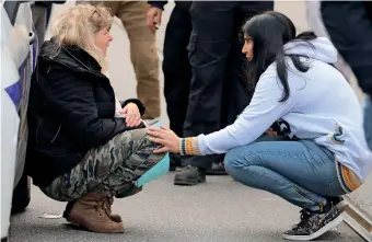  ?? AFP ?? A woman kneels by a police car as she cries in the streets after a knife attack in Nice on Thursday. —