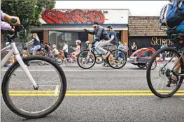  ?? JASON ARMOND Los Angeles Times ?? CYCLISTS enjoy streets without automobile traffic during a CicLAvia event in North Hollywood on Sept. 17. Another CicLAvia was held on Sunday.