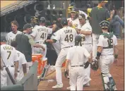  ?? ERIC RISBERG — THE ASSOCIATED PRESS ?? A’s relief pitcher Joakim Soria is greeted by teammates after retiring theWhite Sox during the eighth inning of Game 3of an American League wild-card series on Thursday.