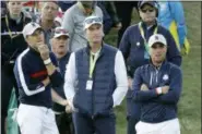  ?? MATT DUNHAM — THE ASSOCIATED PRESS ?? US team captain Jim Furyk, center, Jordan Spieth, left, and Justin Thomas stand around the 8th green during a foursome match against Europe’s Tommy Fleetwood and Europe’s Francesco Molinari on the opening day of the 42nd Ryder Cup at Le Golf National in Saint-Quentin-enYvelines, outside Paris, France, Friday.