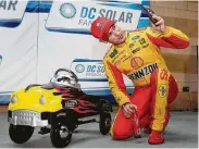  ?? Colin E. Braley / Associated Press ?? Joey Logano snaps a selfie with his pole award trophy after qualifying first for Sunday’s Monster Energy Cup playoff race at Kansas Speedway.