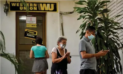  ??  ?? Cubans queue outside a Western Union office in Havana this week. More than 400 Western Union offices in Cuba will close their doors due to new sanctions imposed by the US. Photograph: Yamil Lage/AFP/Getty Images