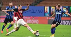  ?? (AFP) ?? AC Milan’s Zlatan Ibrahimovi­c (centre) vies for the ball with Inter Milan’s Christian Eriksen during the Serie A match at the San Siro stadium in Milan.