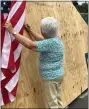  ?? ?? Roberta Lorenz signs on a truss that was then hoisted to its spot atop the new Health Care Center.