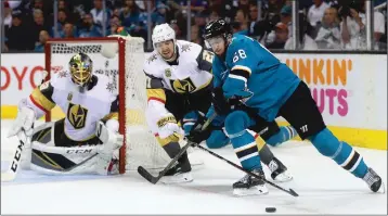  ??  ?? San Jose Sharks forward Melker Karlsson (68) battles Vegas Golden Knights defenseman Shea Theodore (27) for the puck during Sunday’s NHL Stanley Cup Playoffs Game 6 in San Jose.