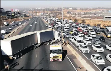  ?? PHOTO: SIMPHIWE MBOKAZI ?? The previous Gauteng taxi strike in Midrand, Johannesbu­rg. Taxi owners apparently had hijacked trucks and blockaded all the N1 Allandale off and on ramps, leaving motorists stranded with their cars.