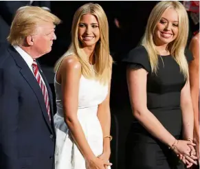  ?? — Reuters ?? Doting father: Trump standing by daughters Ivanka (centre) and Tiffany (right) on the third day of the Republican National Convention in Cleveland.