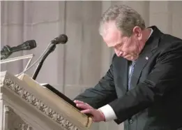  ?? CAROLYN KASTER/AP ALEX BRANDON/AP ?? ABOVE: The flagdraped casket of former President George H.W. Bush is carried by a military honor guard at the conclusion of Bush’s state funeral on Wednesday at the National Cathedral in Washington, D.C. LEFT: Bush’s son, former President George W. Bush, becomes emotional during his tribute to his father.