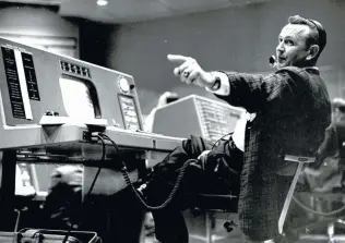  ?? NASA ?? Christophe­r Kraft, flight director during Project Mercury, works at his console at Mercury Mission Control in the 1960s. Kraft had the final say for NASA’s first five manned missions.