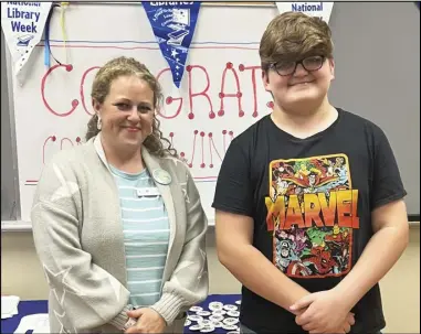  ?? Photo by Special to the MDR ?? Mason Pasley, pictured above stands with Malvern-hot Spring County Library director Claire Graham after winning first place in the 7th-8th grade division of the contest at the library. Other winners include Julieah Douskurt, first place 3rd-4th grade, Holly Grace, second place in 7th-8th, Betty Westerman Ford first place adult, Georgette Mccalley second place adult.