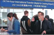  ?? ZOU HONG / CHINA DAILY ?? Travelers apply for up to 144-hour visa-free entry at Beijing Capital Internatio­nal Airport on Thursday. The entry also can be used to visit Tianjin and Hebei province.