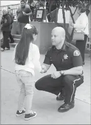  ??  ?? San Jose Police Chief Eddie Garcia speaks with Vanessa Nunez, 6. Garcia tried to calm deportatio­n and raid fears for the congregati­on.