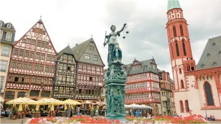  ?? RICK STEVES ?? In Frankfurt’s Romerberg Square, the half-timbered buildings were rebuilt in 1983, after bombs destroyed the originals during World War II.