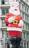  ?? PHOTO: THE NEW ZEALAND HERALD ?? The giant Santa seen on the Whitcoulls building, in central Auckland.