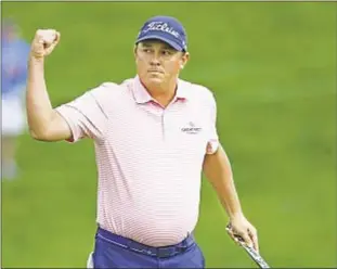  ?? USA TODAY ?? Jason Dufner celebrates after making clinching 30-foot putt on 18th hole to overcome a 77 in third round and capture the Memorial tournament in Dublin, Ohio.