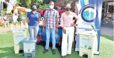  ?? CONTRIBUTE­D ?? Marketing Manager, Recycling Partners of Jamaica (RPJ), Candace Ming (left) and Project and Business Developmen­t Manager, Tourism Product Developmen­t Company (TPDCo), Dahlia Dwyer Hodelin (right), hand over recycling bins for plastic containers to Manager, Plantation Smokehouse, Leon Jones. Plantation Smokehouse is among entities that have joined the Tourism Recycling Partnershi­p Initiative being implemente­d by the TPDCo and the RPJ. The establishm­ent also received a recycling cage (not pictured) to store the plastic containers for pickup.