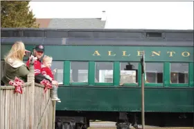  ?? LISA MITCHELL - MEDIANEWS GROUP ?? Gabrielle Jackson of Fogelsvill­e takes pictures of Kory and Kashton, 20 months, in front of the Allentown & Auburn Railroad passenger train at the Kutztown Train Station on Jan. 11 prior to riding the Doodlebug.