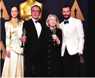  ??  ?? (From left) Actor Dakota Johnson, production designer David Wasco and art director Sandy Reynolds-Wasco, winners of Best Production Design for ‘La La Land’ and actor Jamie Dornan pose in the press room.