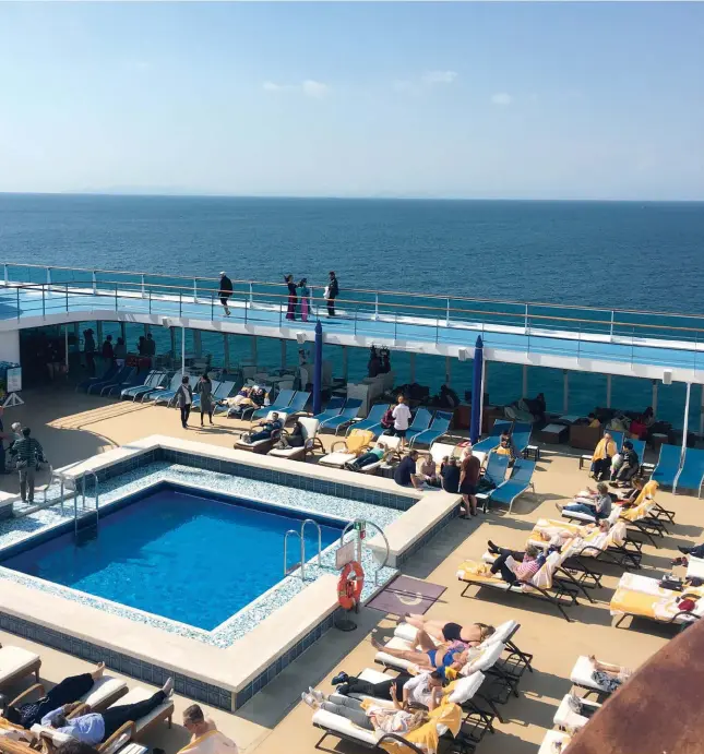  ??  ?? The top deck of Costa
neoRomanti­ca is a favored spot for people to socialize and get some sunshine during the
sailing