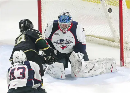  ?? MIKE HENSEN ?? Liam Foudy of the Knights rings a shot off the post as Spitfires goalie Mikey DiPietro was able to get a bit of the puck with his shoulder during game at Budweiser Gardens on Monday in London.