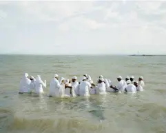  ??  ?? Mass baptism 23/08/2013, 3.30 pm Southendon-Sea approx. 180 biannually 51°31’54.6”N 0°43’32.7”E overcast (© Chloe Dewe Mathews 2021, courtesy Loose Joints)