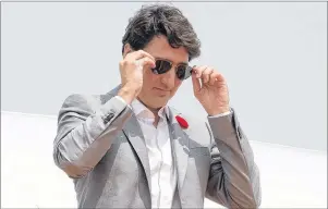  ?? ADRIAN WYLD/CP PHOTO ?? Prime Minister Justin Trudeau was photograph­ed on Thursday arriving in Vietnam wearing a pair of sunglasses from a P.E.I. business.