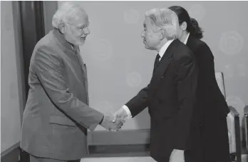  ?? — PTI ?? Prime Minister Narendra Modi shakes hands with Japanese Emperor Akihito in Tokyo on Tuesday.