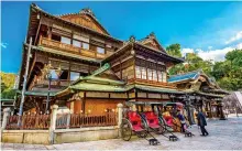  ??  ?? STEPPING BACK IN
TIME: The beautifull­y ornate wooden balconies at the Dogo resort