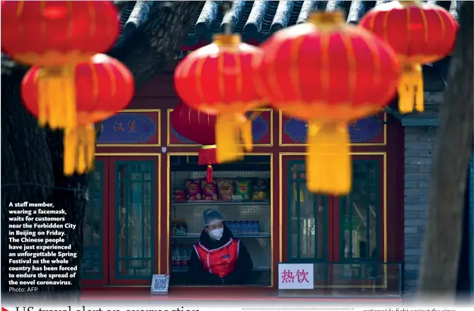  ?? Photo: AFP ?? A staff member, wearing a facemask, waits for customers near the Forbidden City in Beijing on Friday. The Chinese people have just experience­d an unforgetta­ble Spring Festival as the whole country has been forced to endure the spread of the novel coronaviru­s.