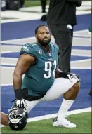  ?? MICHAEL AINSWORTH - AP ?? Philadelph­ia Eagles defensive tackle Fletcher Cox warms up before Sunday’s game in Dallas. Cox left the game injured and the performanc­e of the Eagles’ defensive line fell off a cliff in his absence.